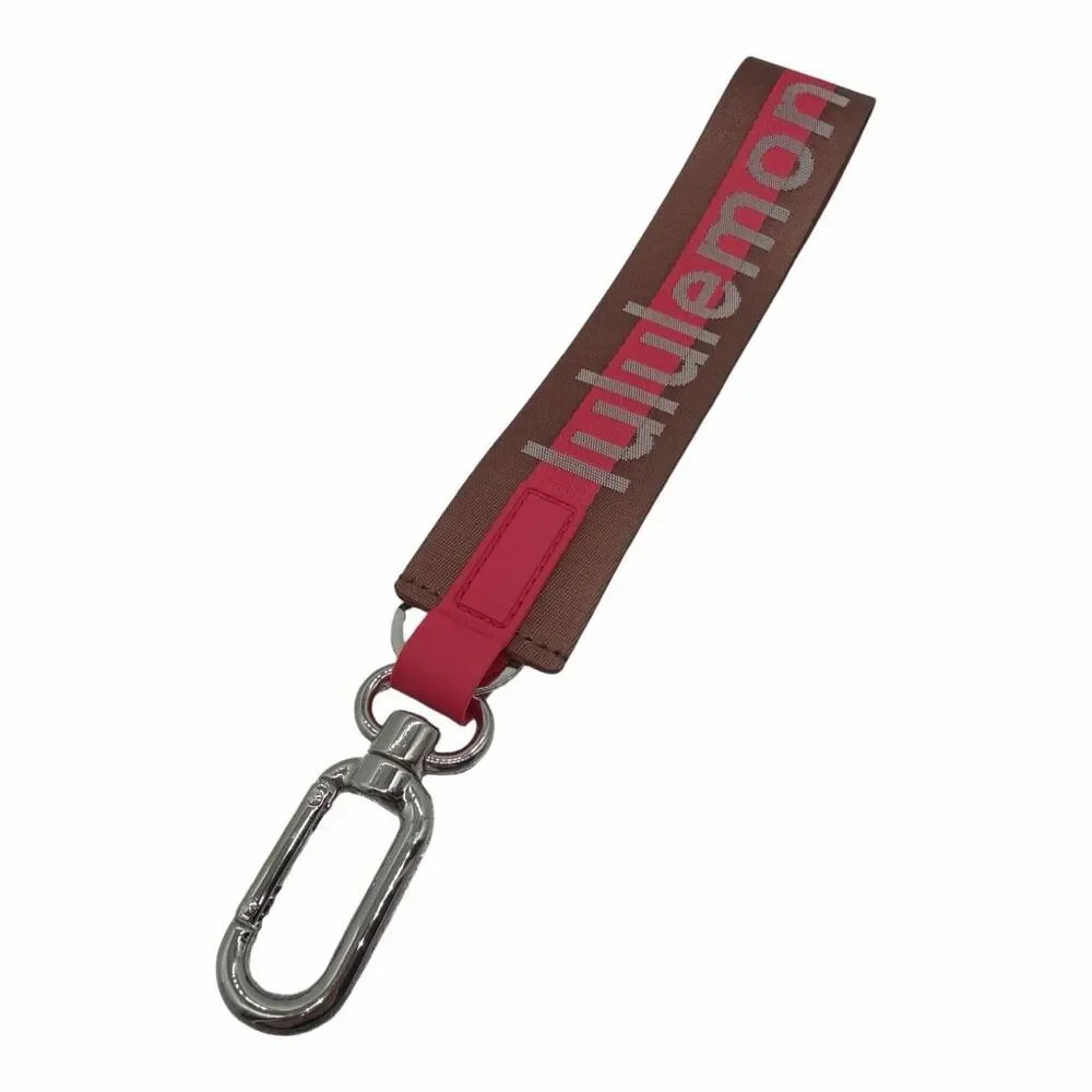 NWOT LULULEMON NEVER LOST KEYCHAIN WORDMARK PINK AND BROWN COLOR ONE SIZE
